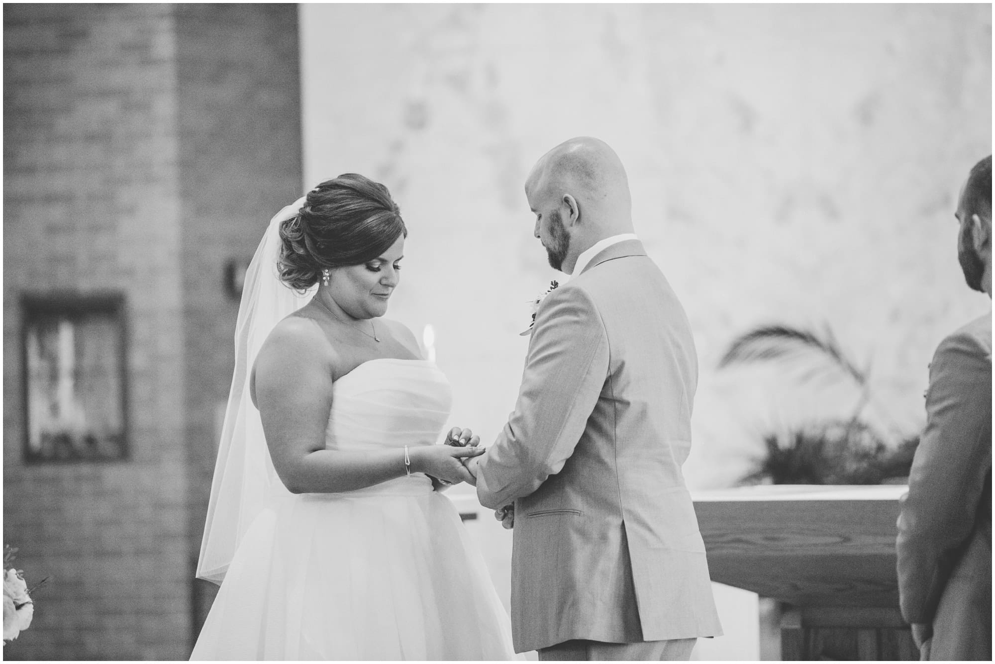 exchanging of the rings in black and white at naperville wedding